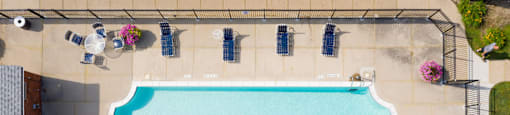 arial view of a swimming pool with umbrellas around it