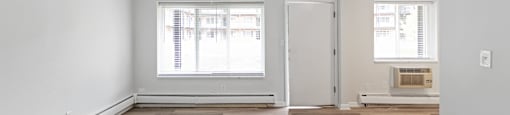 A room with a window and a door.