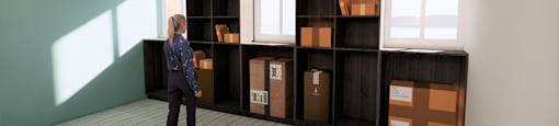 A woman is standing in a room with a shelving unit.