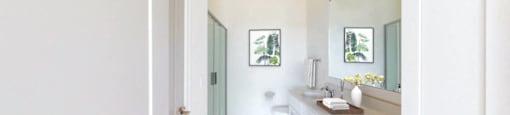 A bathroom with a white door and a white sink.