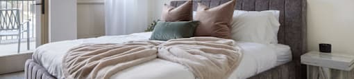 a bedroom with a large bed and a window