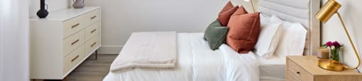 a bedroom with a bed and a dresser