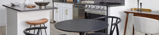 a kitchen and dining area with a table and chairs
