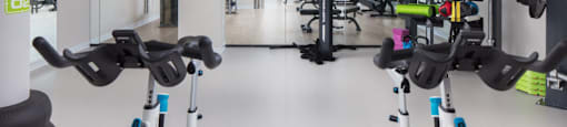 a gym with weights and cardio equipment in a health club