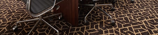 A conference room with a large table and chairs.