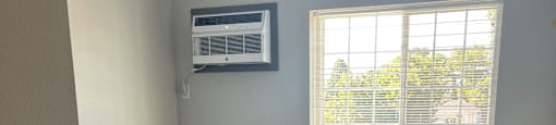 an empty room with carpet and a window