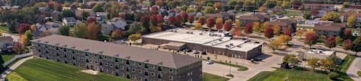 an aerial view of the barracks complex with a green field in the foreground
