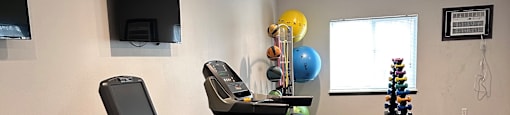A gym with treadmills and exercise bikes.