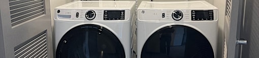 two washers and dryers in a laundry room