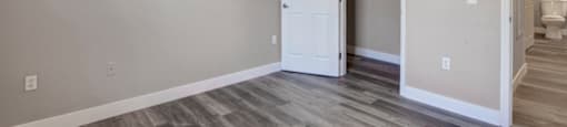 a bedroom with hardwood floors and a ceiling fan