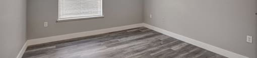 a bedroom with hardwood floors and a ceiling fan