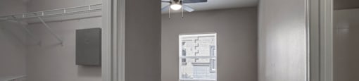 an empty bedroom with a ceiling fan