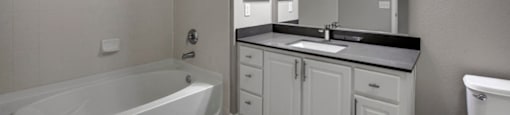 a bathroom with a bathtub and a sink