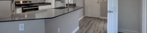 a kitchen with a counter top and a stove top oven