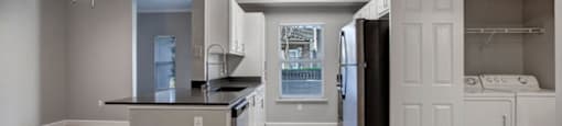 a kitchen with a stove top oven next to a refrigerator