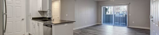 a kitchen and a living room with a sliding glass door