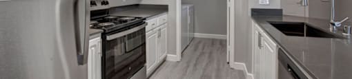 a kitchen with a stove top oven next to a refrigerator