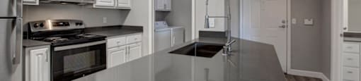a kitchen with a large counter top and a stove top oven