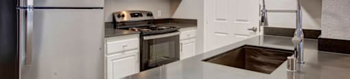 a kitchen with a sink stove and refrigerator