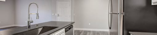 a kitchen with a sink and a refrigerator