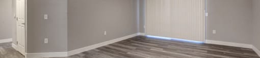 an empty living room with a ceiling fan