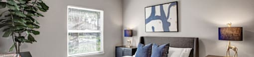 a bedroom with a bed and a ceiling fan