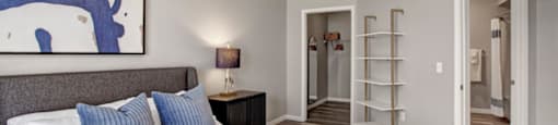 a bedroom with a large bed and a ladder in the background