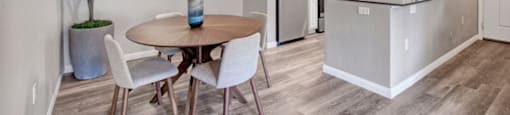 a kitchen and dining room with a table and chairs