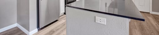 a kitchen with a counter top and a refrigerator