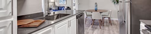 a kitchen and living room with a table and chairs
