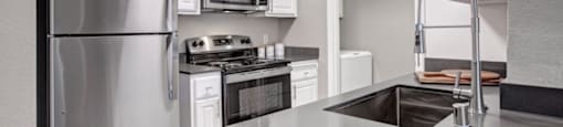 a kitchen with a sink and a refrigerator