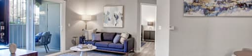 a living room with a couch and a ceiling fan