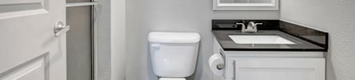 a bathroom with a toilet sink and shower