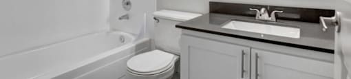a bathroom with a sink toilet and bathtub