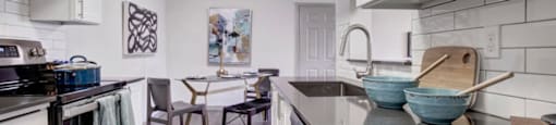 a kitchen and dining room with a table and chairs