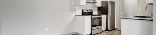 a kitchen with a stove top oven next to a refrigerator
