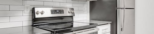 a kitchen with a stove and a refrigerator