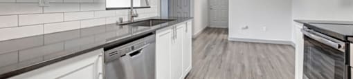 a kitchen with a dishwasher a sink and a stove