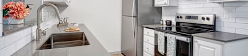 a kitchen with a sink stove and refrigerator