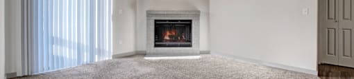 a living room with a fireplace and a window