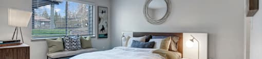 a bedroom with a large bed and a large window