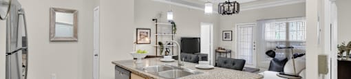 A kitchen with a granite countertop and a refrigerator.