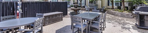 our yard with tables and chairs and umbrellas at our apartments on the strip