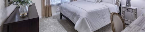 a bedroom with a large bed and a ceiling fan