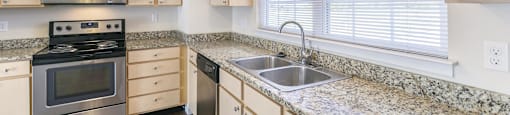a kitchen with granite counter tops and stainless steel appliances