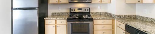 a kitchen with stainless steel appliances and granite counter tops