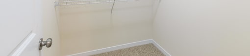 a spacious walk in closet with shelves in a white room