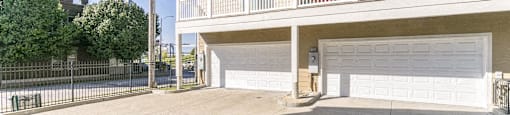 a large white garage door in front of a house