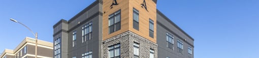 a brick and wood building on the corner of a city street
