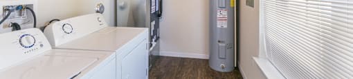 a laundry room with a washer and dryer and a water heater